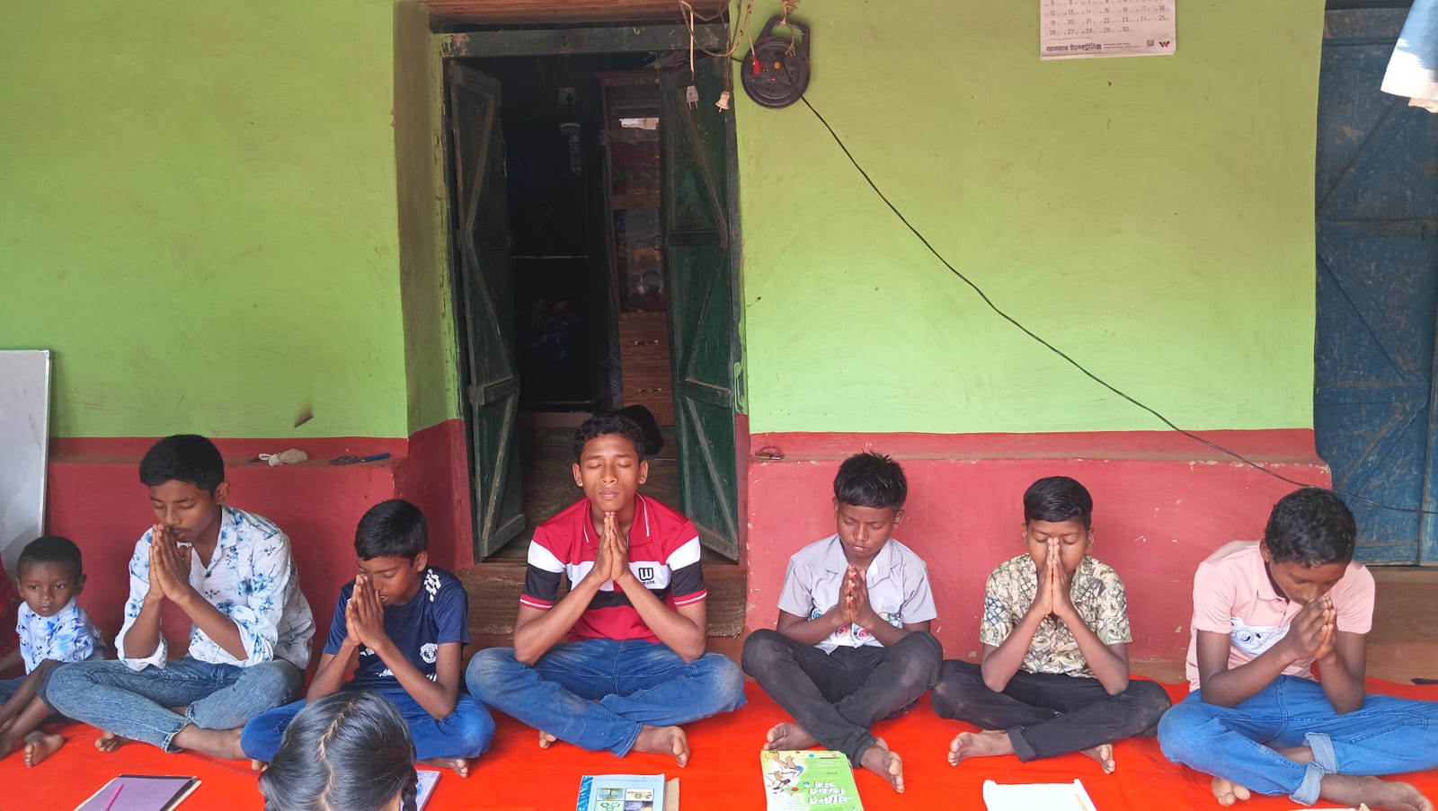 Children praying together in a village school